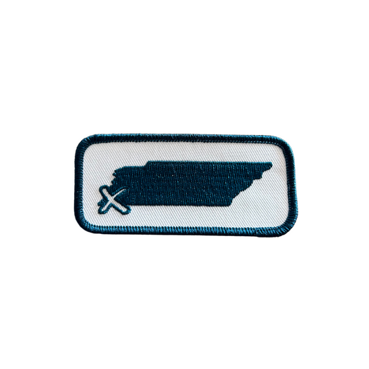 State "X" Patch from Choose901 Merch Shop featuring a blue ship silhouette with a crossed-out anchor symbol on a white background with a blue border, celebrating Memphis's Choose901 campaign.