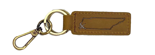 A State with an X Brown Leather Keychain from the Choose901 Merch Shop, with a metallic key ring and clip, featuring an embossed outline of a coffin on the tag.