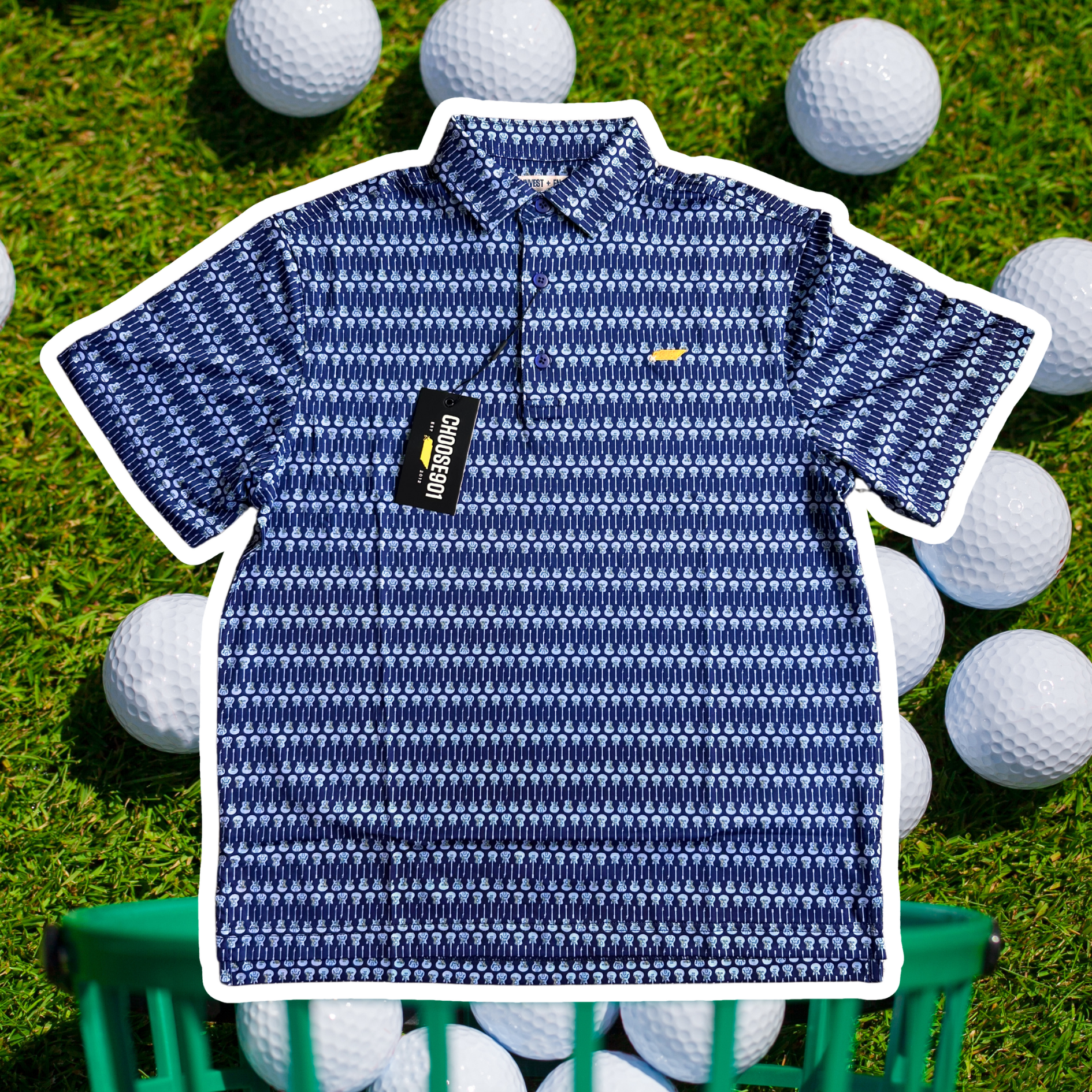 The Kings' Guitar Polo, a patterned blue quick dry shirt from Choose901 Merch Shop, is displayed with its tag on grass surrounded by golf balls.