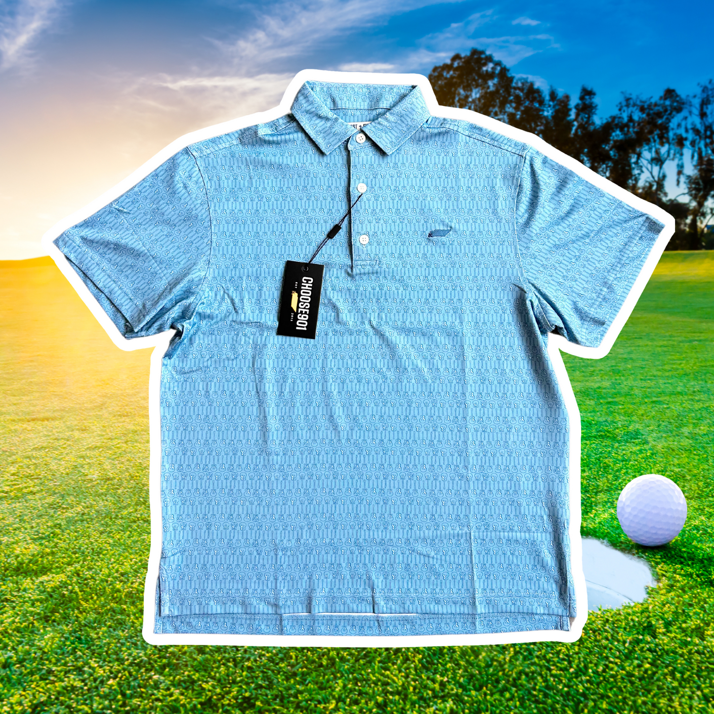 A light blue quick-dry polo shirt, The Kings' Guitar Polo from the Choose901 Merch Shop, featuring a patterned design is displayed against a backdrop of a golf course with a visible golf ball and hole. A tag attached to the collar reads "ON PAR DESIGN.