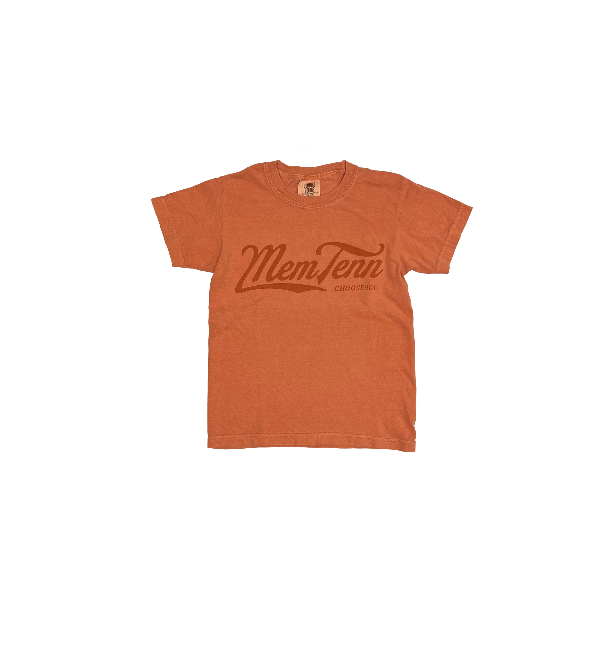 An orange Comfort Colors t-shirt with "Youth Memphis Tenn Cursive on Terracotta" printed in the center, hanging on a white hanger against a striped background.