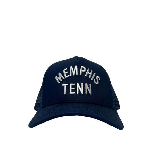 Memphis Tenn Navy Blue Trucker Hat with "901" embroidered in white, displayed against a grey striped background from Choose901 Merch Shop.