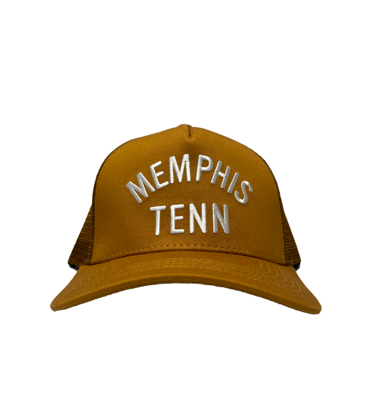Brown snapback cap with the words "Memphis Tenn" embroidered in white on the front, displayed on a striped background.