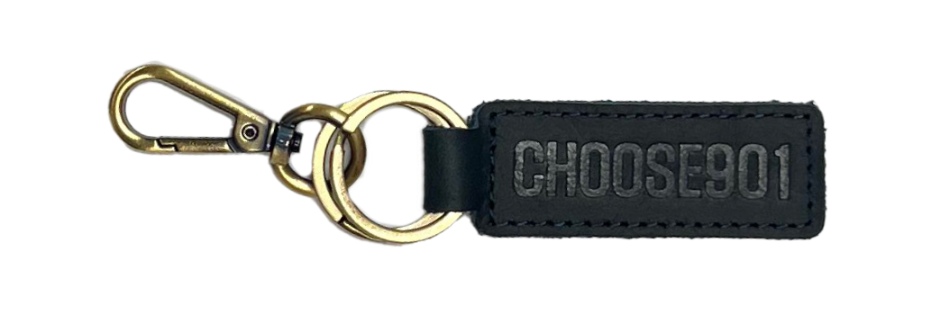 A State with an X Blue Leather Keychain featuring a gold clip attached to a black fabric tag with the words "choose joy" embossed in dark letters. (Choose901 Merch Shop)