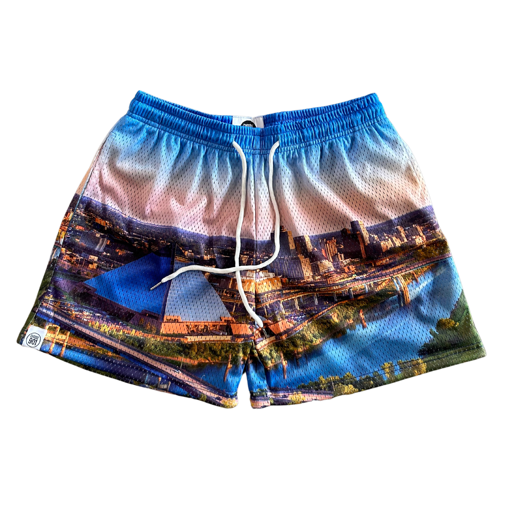 The Memphis Day Shorts from Choose901 Merch Shop are stylish, multicolored swim trunks featuring a cityscape print design. They come with a drawstring at the waist and have breathable mesh shorts lining for added comfort.