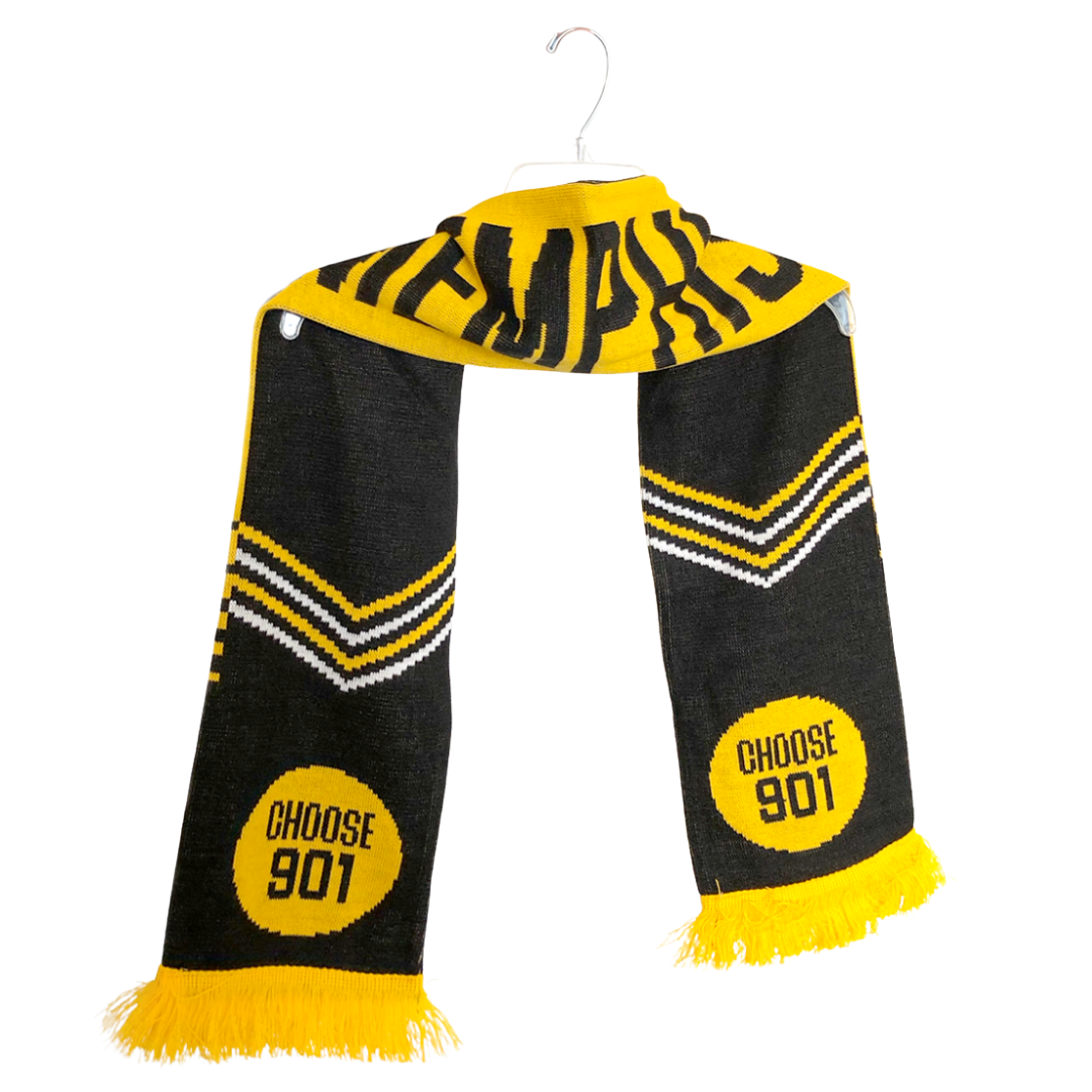 The CHOOSE901 SCARF from Choose901 Merch Shop, featuring bold black and yellow colors and adorned with the words "Choose 901" and "Memphis," drapes gracefully on a hanger, offering a cozy embrace akin to a pass to a sunny town.